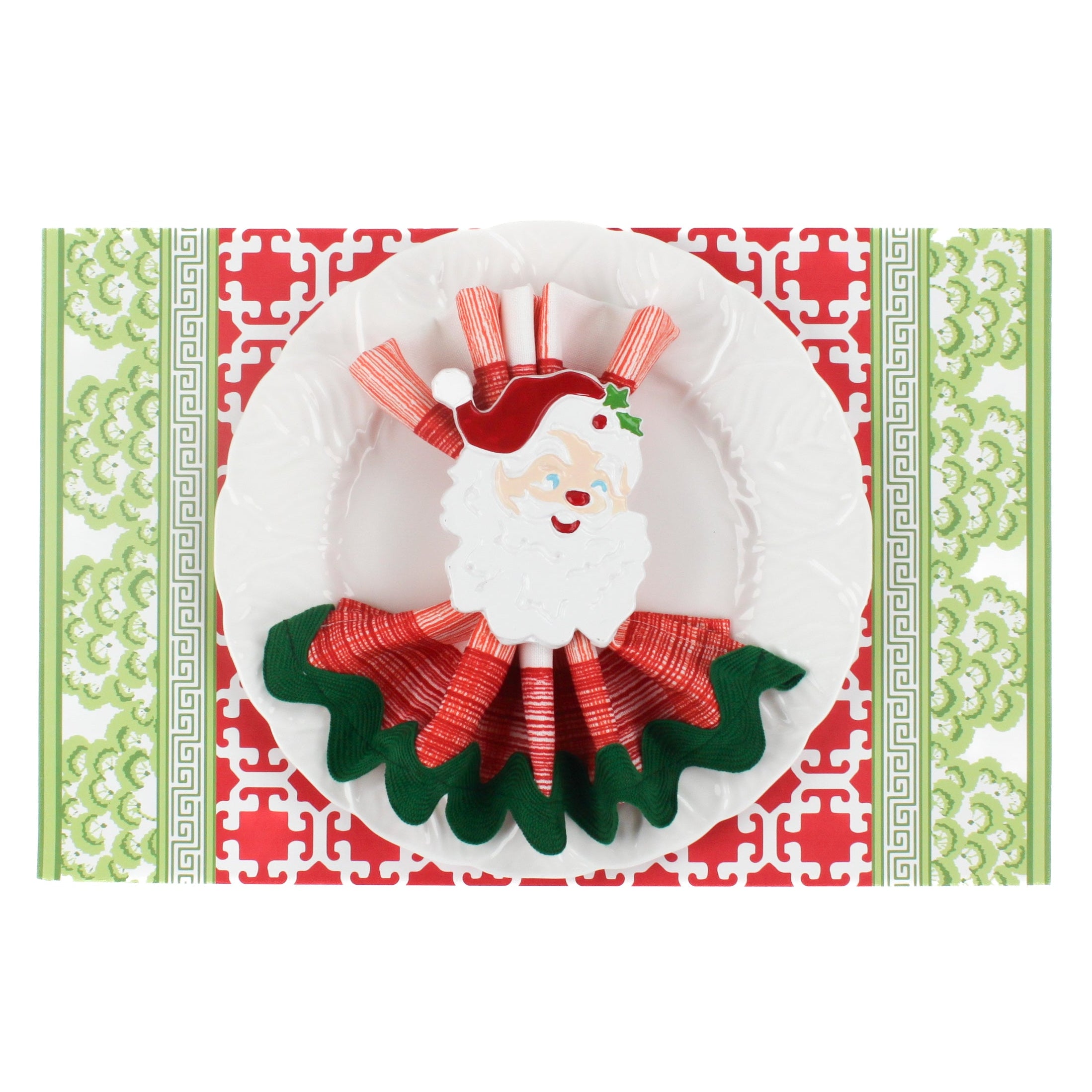 green and red paper placemats in a trellis pattern called "Monserrat" by Madcap Cottage. A white plate is placed on top of it with a cloth and a santa napkin ring