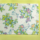 a springtime strawberry print fabric easter table runners in multicolors.