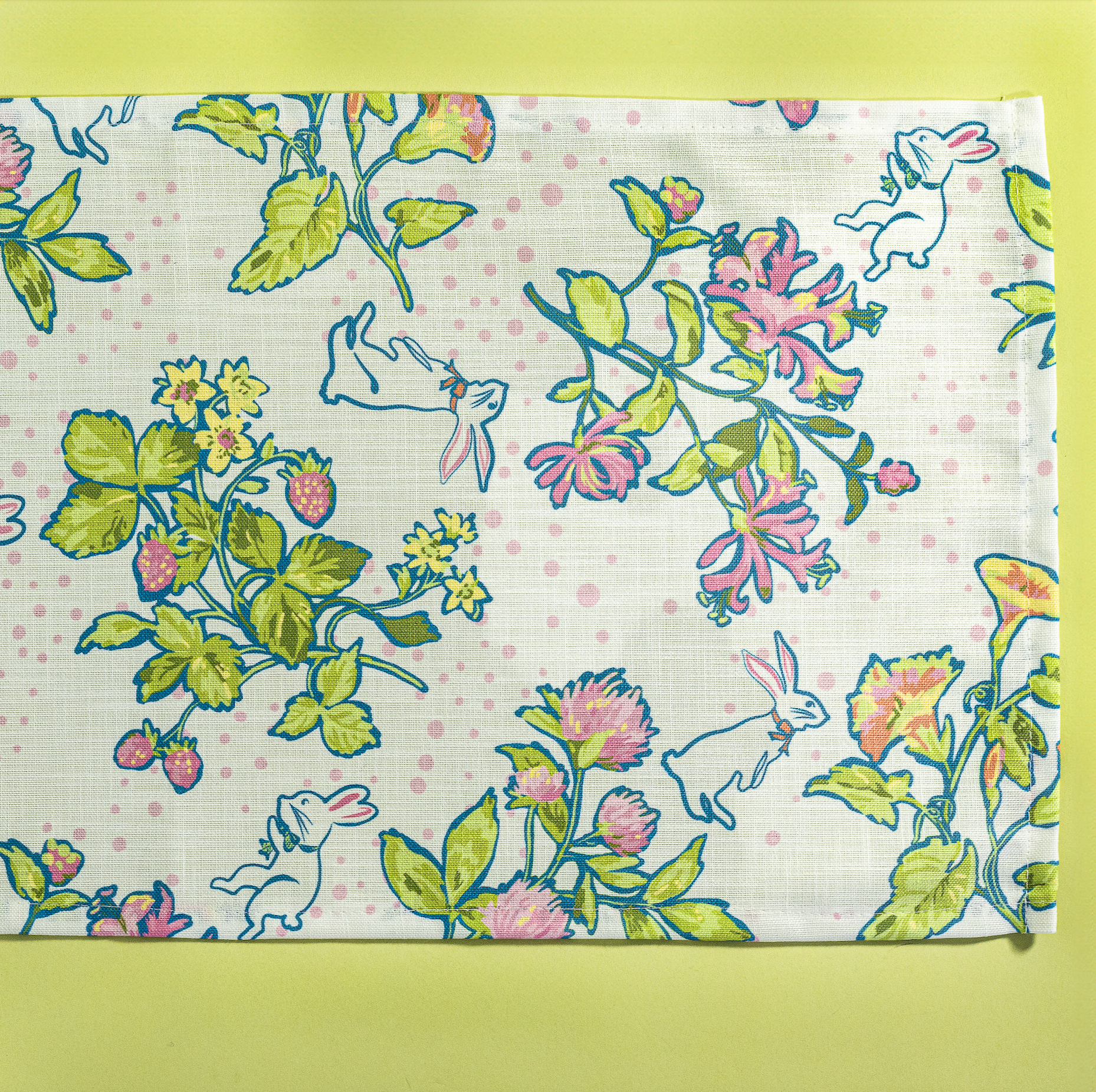 a springtime strawberry print fabric easter table runners in multicolors.