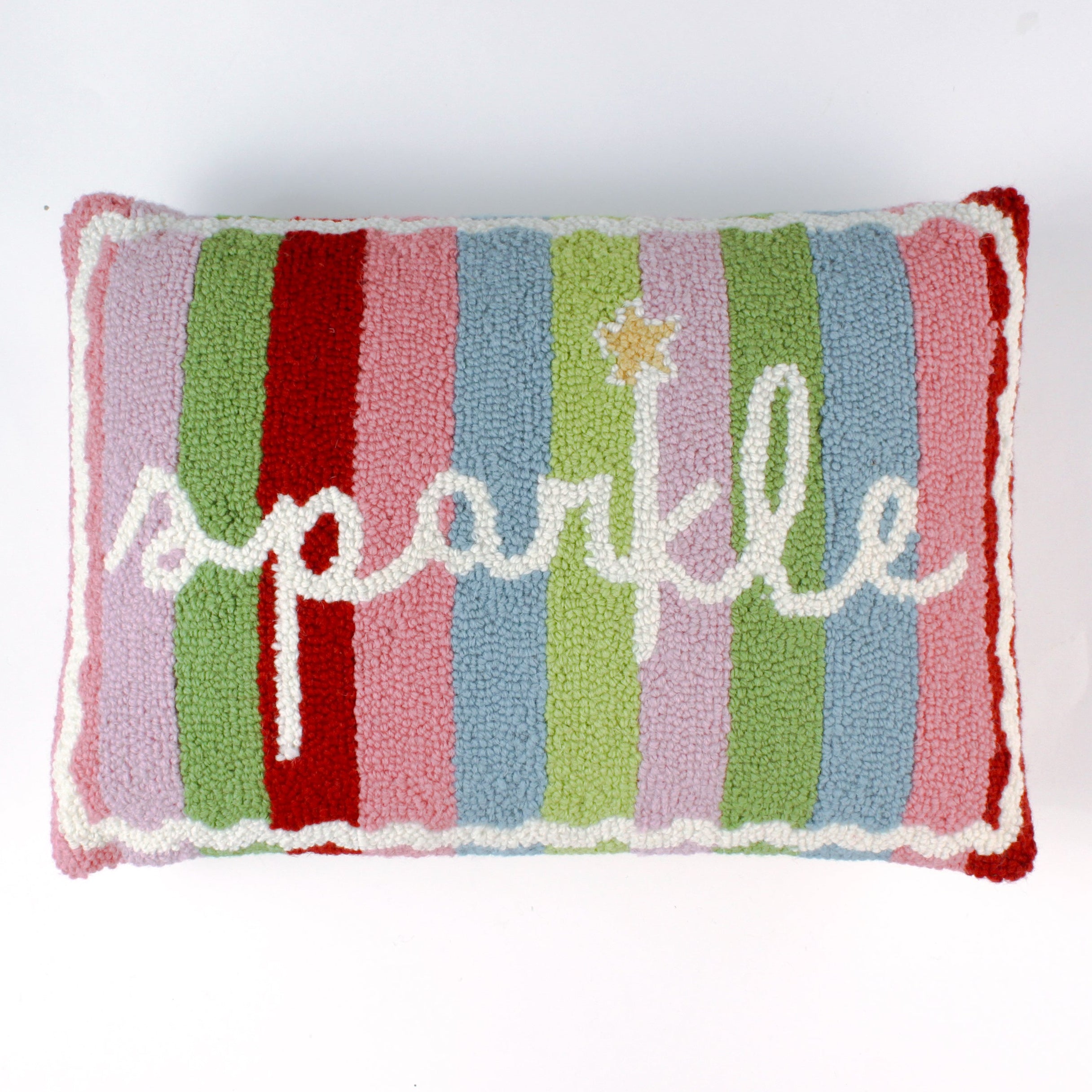 Rectangular colorful pillow with vertical stripes in red, pink, green, blue, and lavender, featuring the word “sparkle” written in white cursive with a small gold star above the letter “k.”