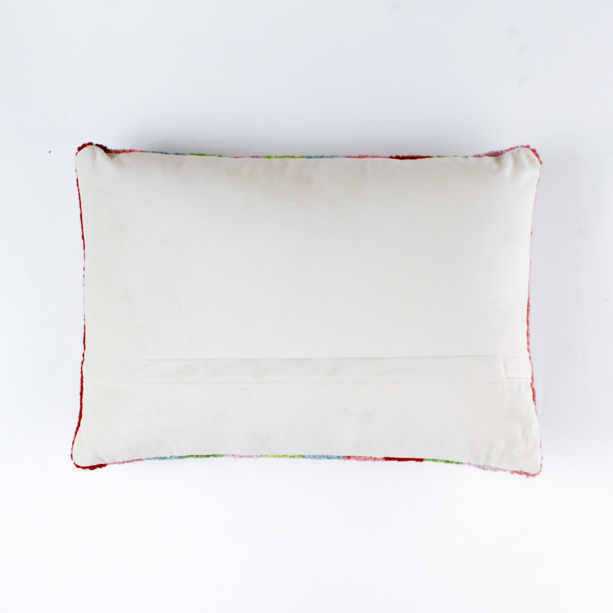 back of a Rectangular pillow with colorful vertical stripes in red, pink, green, blue, and lavender, featuring the word “sparkle” written in white cursive with a small gold star above the letter “k.”