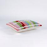 side of a Rectangular pillow with colorful vertical stripes in red, pink, green, blue, and lavender, featuring the word “sparkle” written in white cursive with a small gold star above the letter “k.”