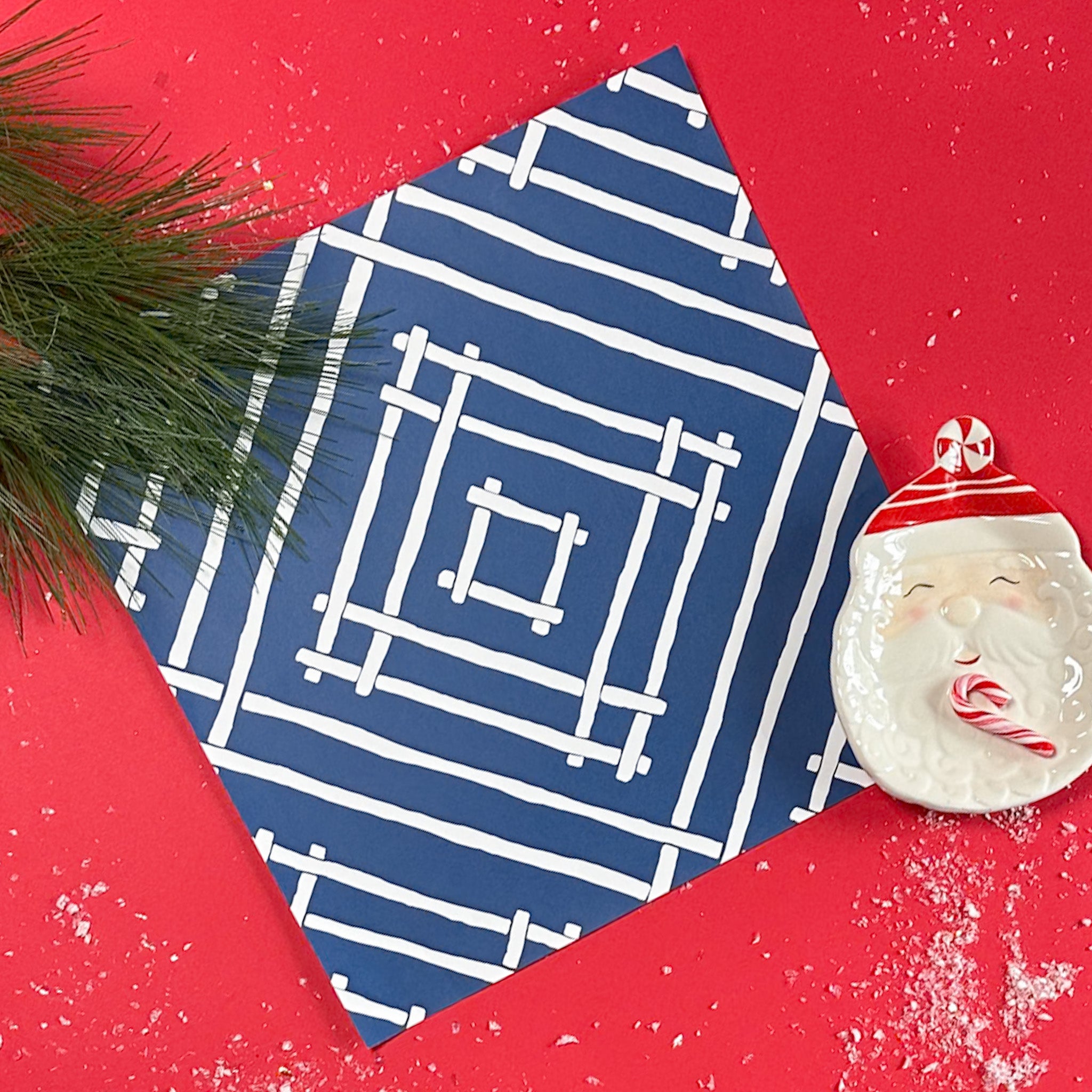 a square blue paper placemats with a white bamboo trellis design from Madcap Cottage.