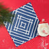 a square blue paper placemats with a white bamboo trellis design from Madcap Cottage.
