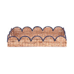 side view of a scalloped rattan tray with navy blue trim