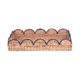 side view of a scalloped rattan tray with navy blue trim
