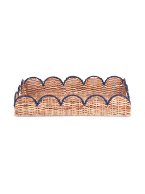 side view of a scalloped rattan tray with navy blue trim