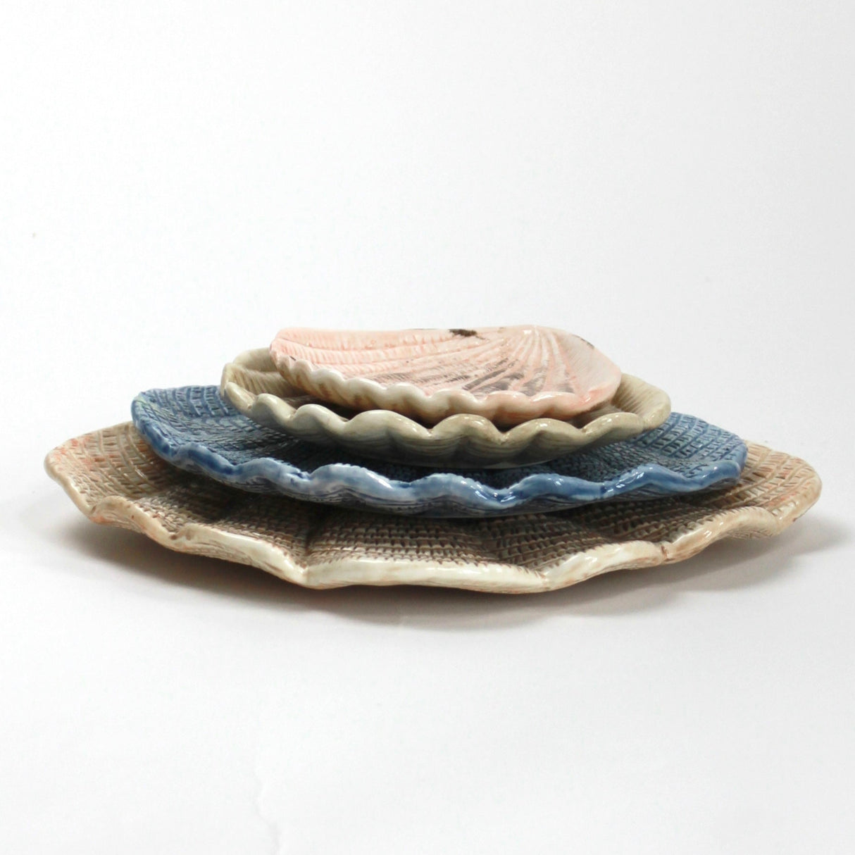 A collection of 4 nested ceramic shell bowls in graduating sizes from madcap cottage