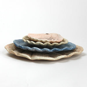 A collection of 4 nested ceramic shell bowls in graduating sizes from madcap cottage