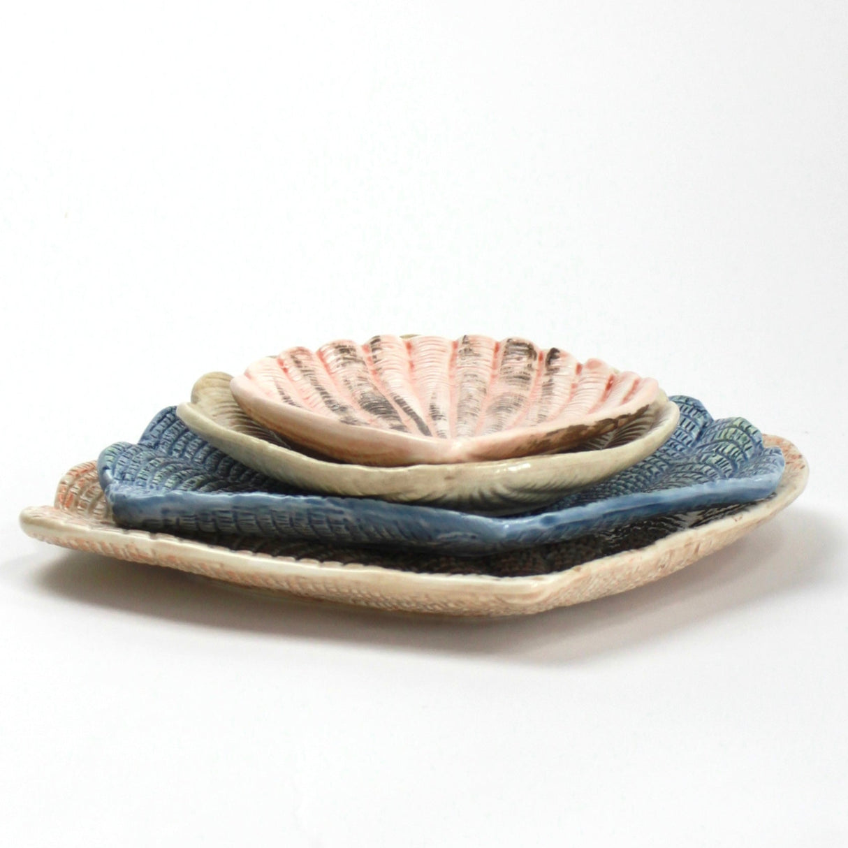 A collection of 4 nested ceramic shell bowls in graduating sizes from madcap cottage