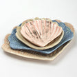 A collection of 4 nested ceramic shell bowls in graduating sizes from madcap cottage