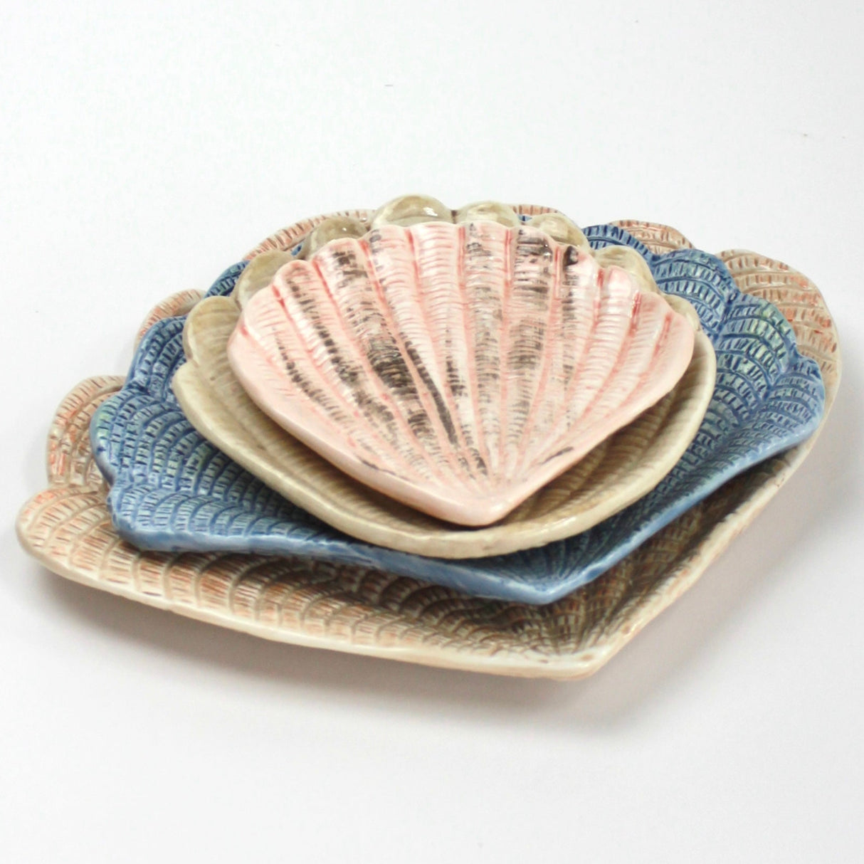 A collection of 4 nested ceramic shell bowls in graduating sizes from madcap cottage