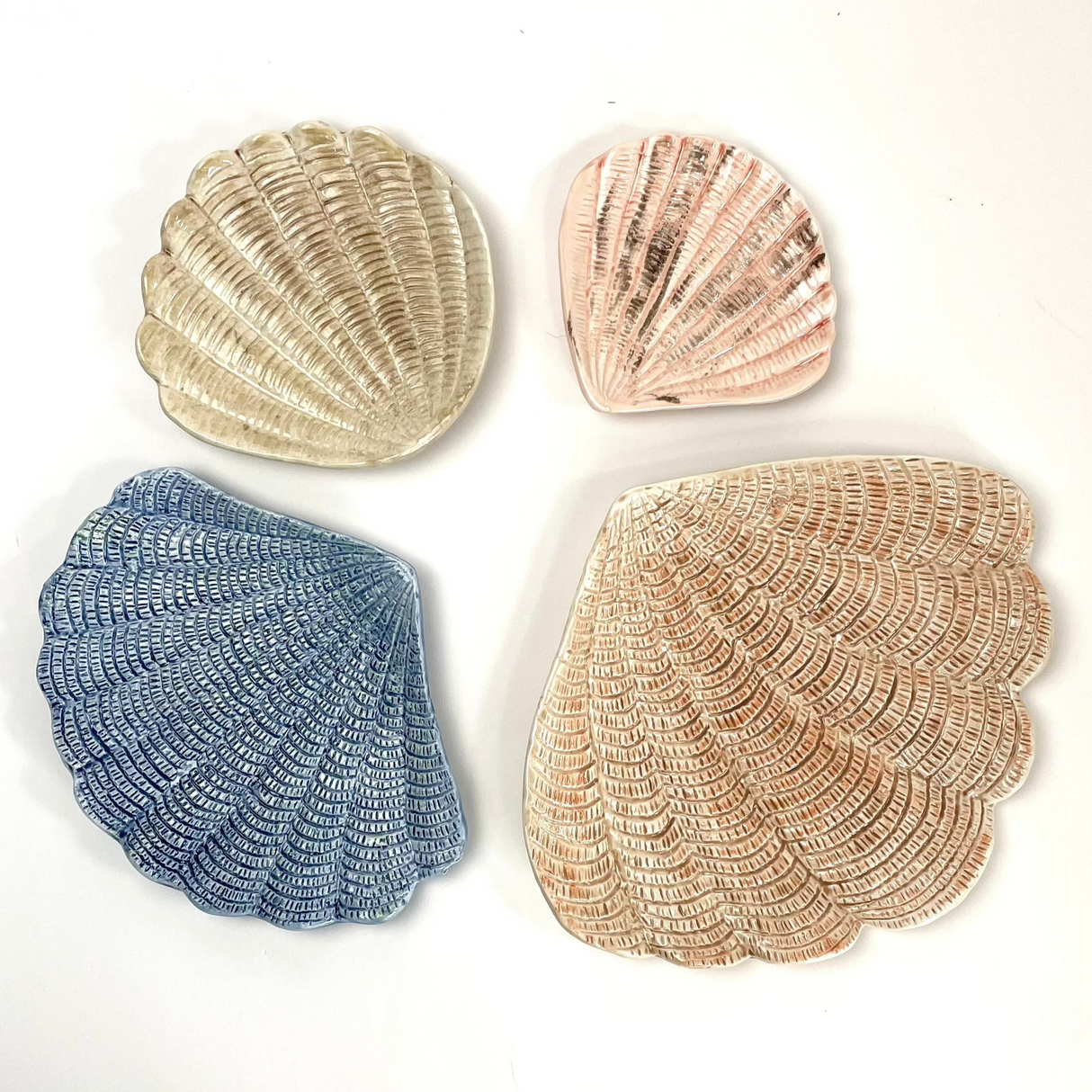A collection of 4 nested ceramic shell bowls in graduating sizes from madcap cottage