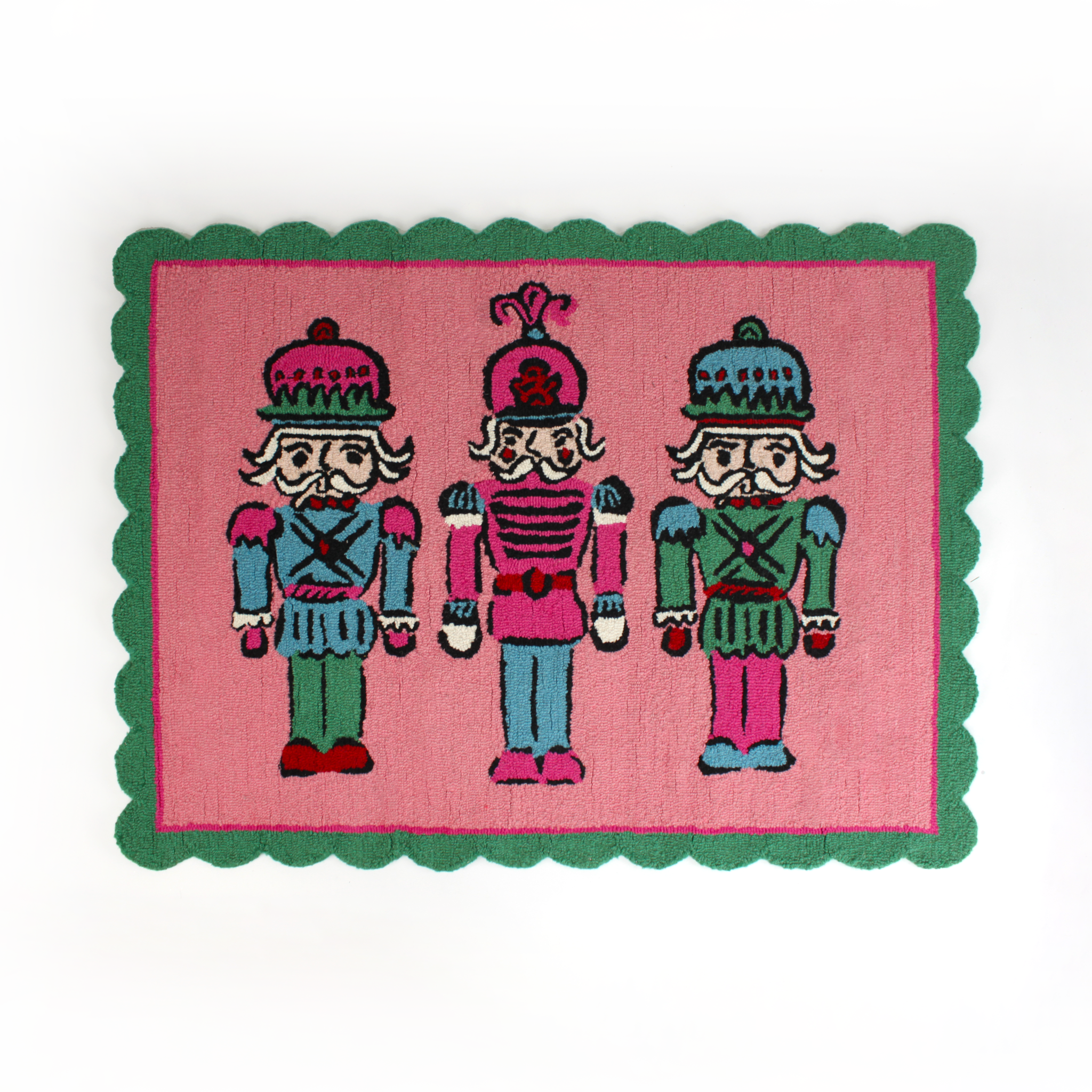 PInk and green christmas rug featuring three nutcrackers and a green scalloped border