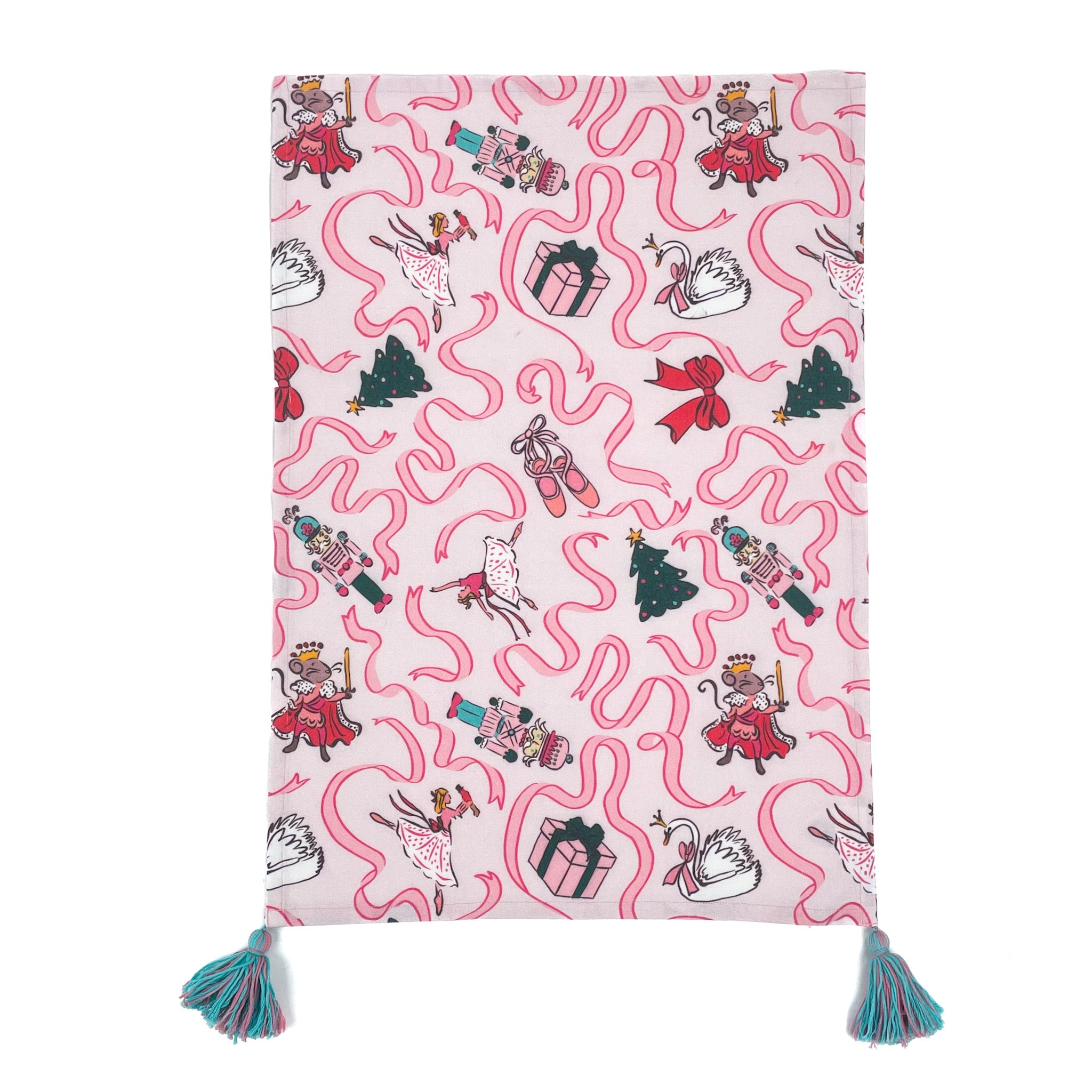 a pink christmas tea towel with nutcracker ballet motifs of swans, ribbons, christmas trees, ballerinas and nutcrackers against a white background. 