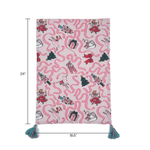 a pink christmas tea towel with nutcracker ballet motifs of swans, ribbons, christmas trees, ballerinas and nutcrackers against a white background with dimension notation of 24" x 18.5"