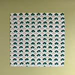 a white and green dinner napkin featuring a triangular block print motif called Old Jaipur from Madcap Cottage.