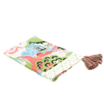 a blue, green and pink chinoiserie tea towel with pink and green tassels against a white background. 