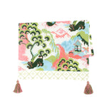 a blue, green and pink chinoiserie tea towel with pink and green tassels against a white background. 