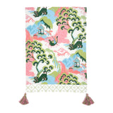 a blue, green and pink chinoiserie tea towel with pink and green tassels against a white background. 
