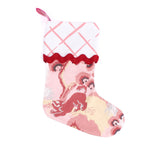 a pink christmas stocking with a pink and white lattice design cuff and a pink and yellow chinoiserie pattern stocking. 