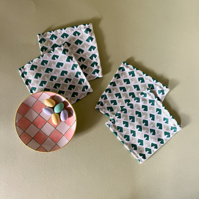 four old jaipur green white cocktail coasters and a plaid plate