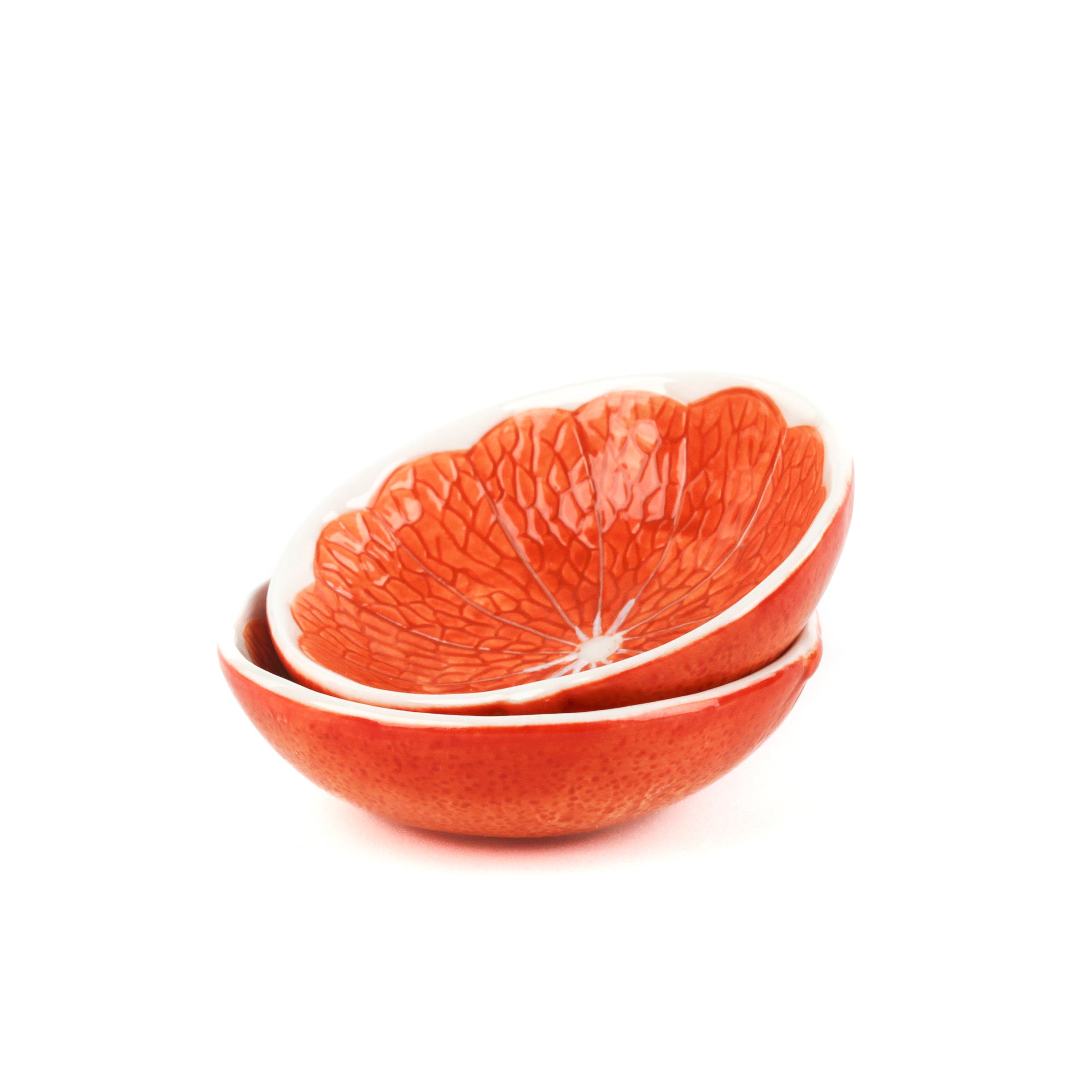two stacked bowls that look like orange halves against a white background. 
