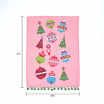 Pink christmas tea towel with colorful ornament designs on a white background with dimension markers for 24" x 18"