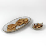 two shell shaped stoneware dishes - the larger in a clam shape, the smaller in an oyster shape