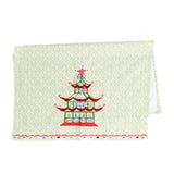 folded in half Christmas Pagoda Tea Towel with some embroidery on green and white background