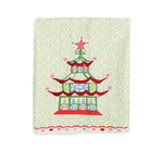 folded Christmas Pagoda Tea Towel with some embroidery on green and white background