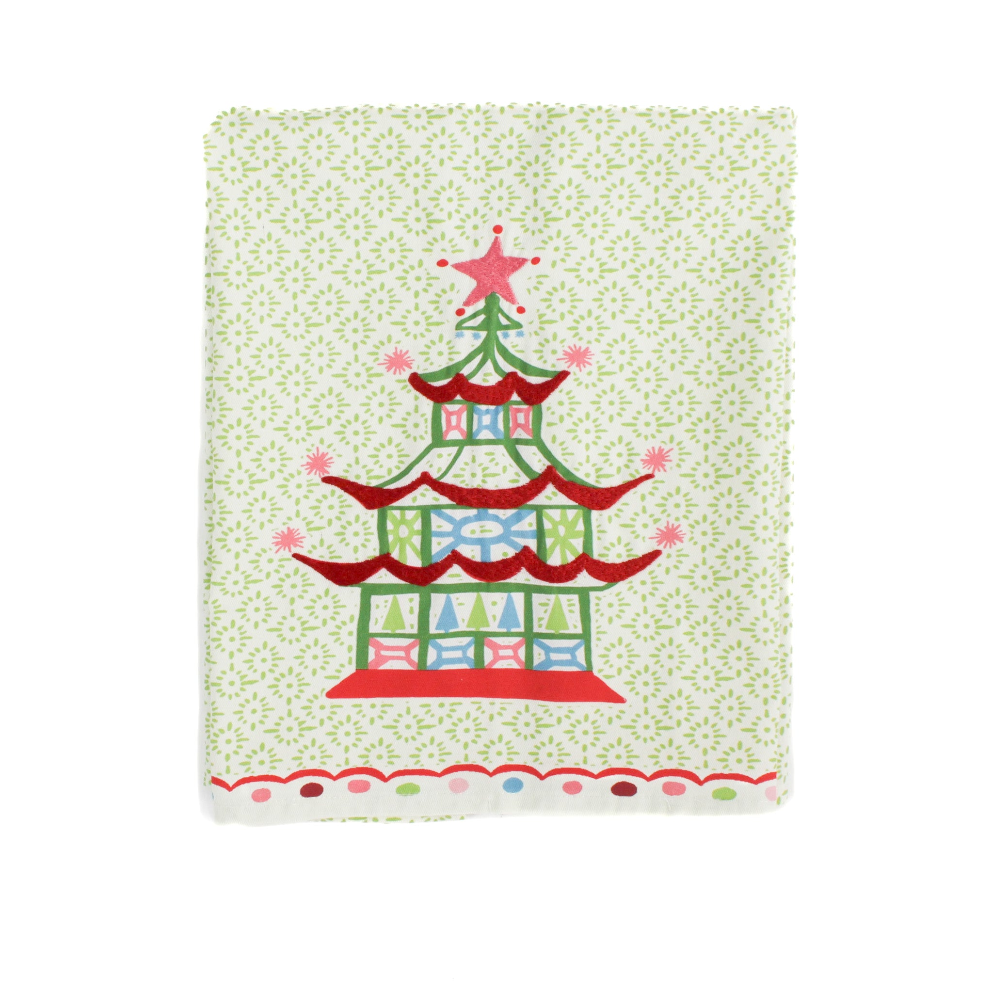 folded Christmas Pagoda Tea Towel with some embroidery on green and white background
