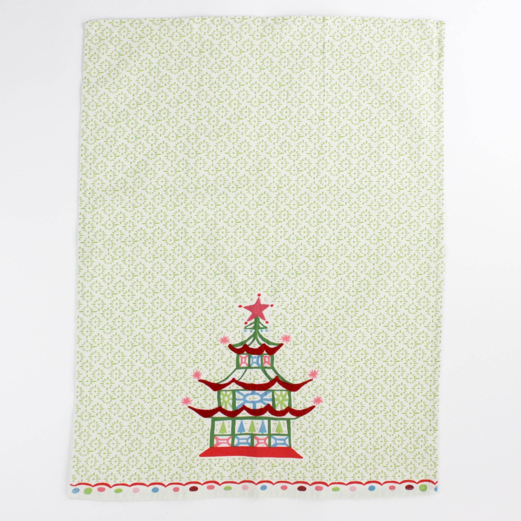 Christmas Pagoda Tea Towel with some embroidery on green and white background