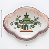 Decorative plate with floral and pagoda design, measurements indicated.