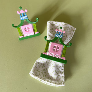 Chinoiserie Pagoda Painted-Metal Napkin Rings with one on a green and white dinner napkin