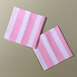 two pink striped napkins in a print named "Cabana Boy" by Madcap Cottage. 