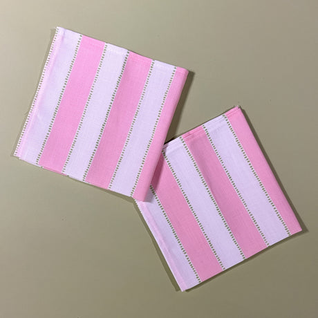 two pink striped napkins in a print named "Cabana Boy" by Madcap Cottage. 