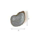 Small gray ceramic oyster-shaped dish with textured edge, shown on a white background with dimensions 3 inches wide and 4 inches tall.