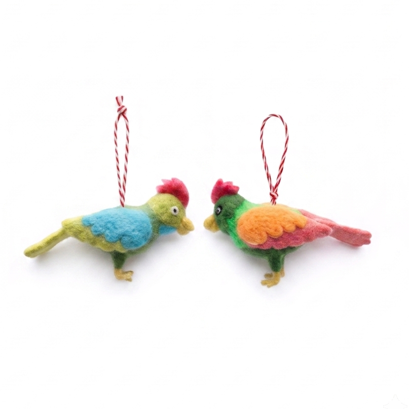 Two colorful felt bird ornaments hanging from red strings on a plain white background.