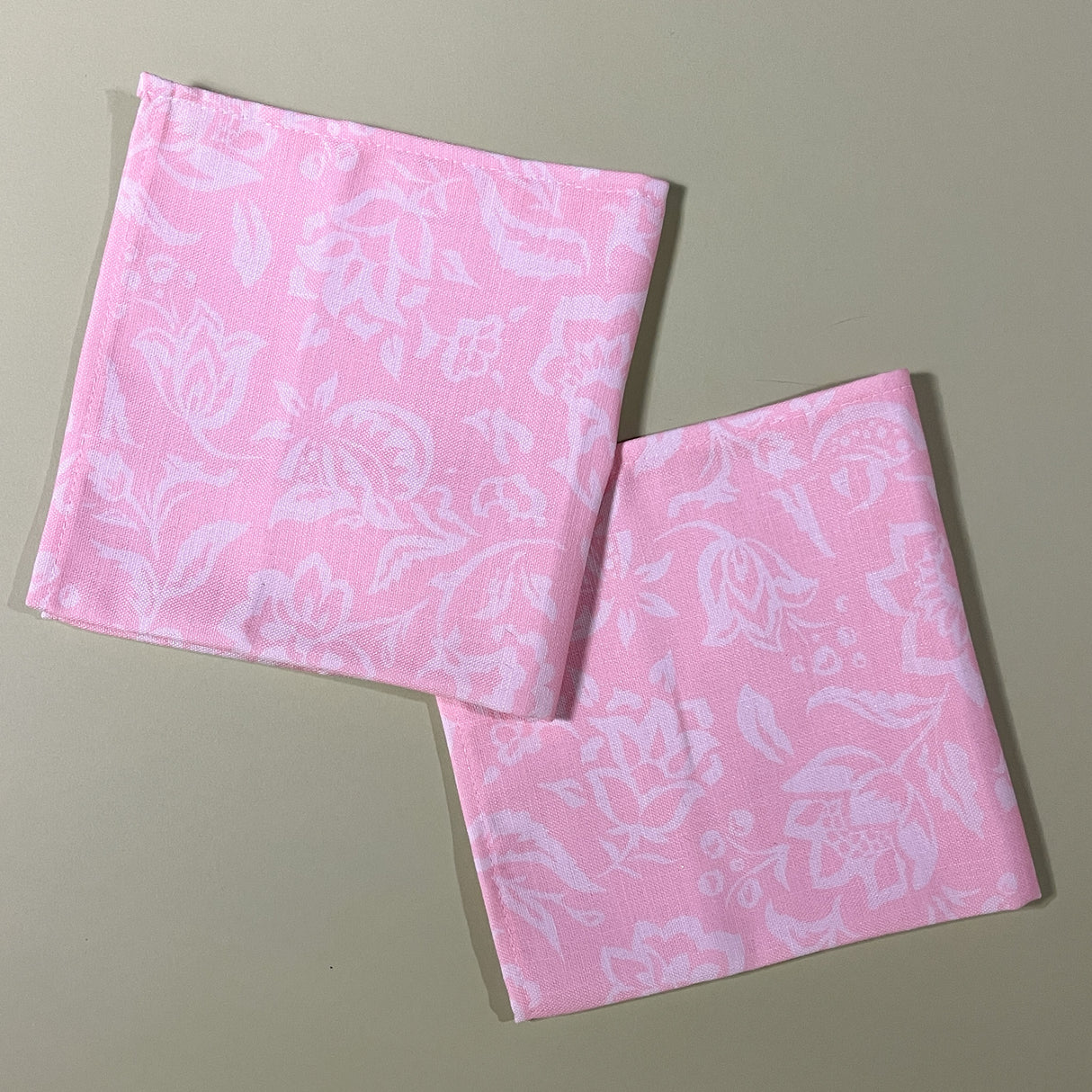 a pair of floral shell pink cloth dinner napkins in madcap cottages hampton court print.