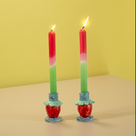 a pair of ceramic strawberry candle holders with strawberries forming the base.