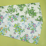 a pair of springtime strawberry print fabric table runners in green and multicolour.
