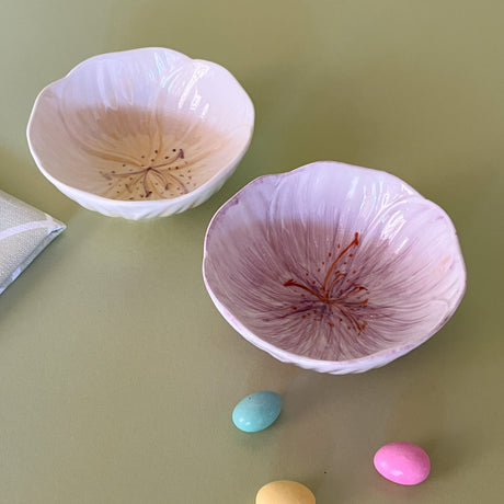 two flower shaped bowls on a table