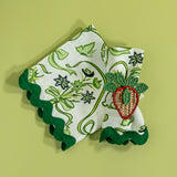 Bunnies and bow print fabric easter napkins in green with a strawberry napkin ring against a green background. 