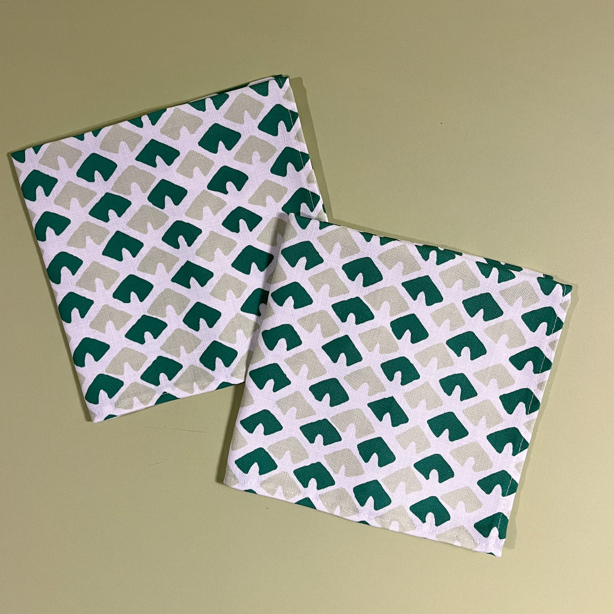 white and green napkins featuring a triangular block print motif called "Old Jaipur" from Madcap cottage. 