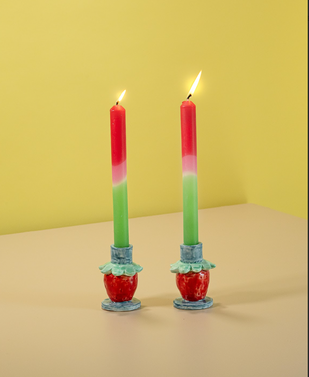 a pair of ceramic strawberry candle holders with strawberries forming the base.