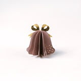 Single pastel paper Christmas bell ornaments in pink with metallic gold bows and dotted accents