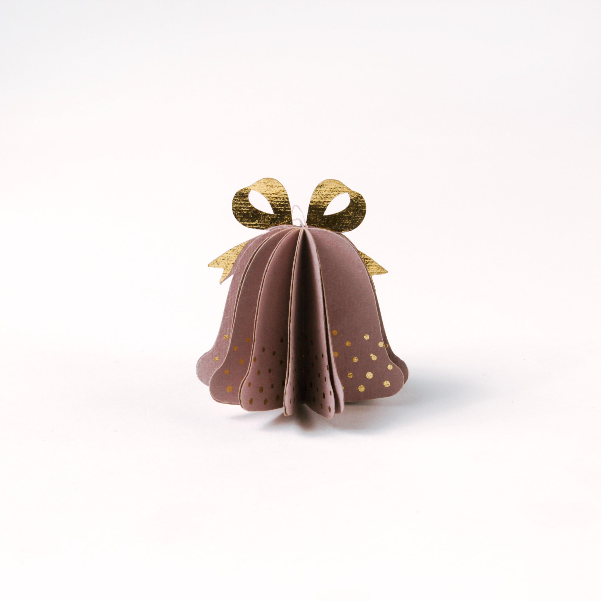 Single pastel paper Christmas bell ornaments in pink with metallic gold bows and dotted accents