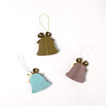 Set of pastel paper Christmas bell ornaments in blue, brown, and pink, featuring metallic gold bows and dotted details