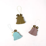 Set of pastel paper Christmas bell ornaments in blue, brown, and pink, featuring metallic gold bows and dotted details